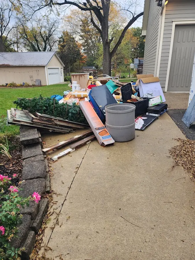 Dumpster being loaded with debris for Estate Cleanout Dumpster Rental in Redwood Falls